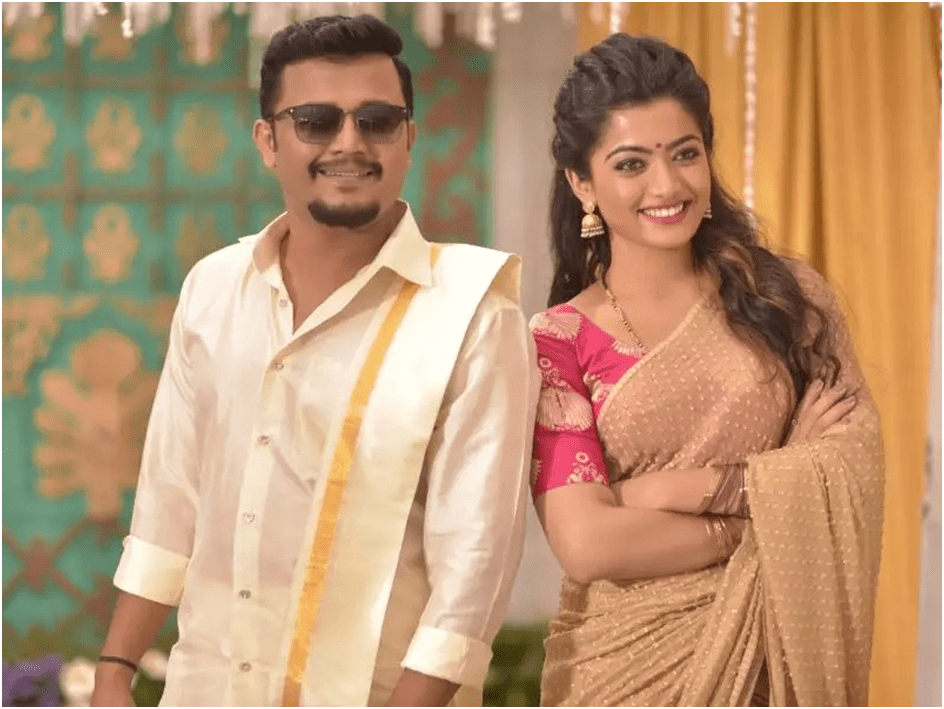 Rashmika wearing a sarree posing for photograph with her co-star