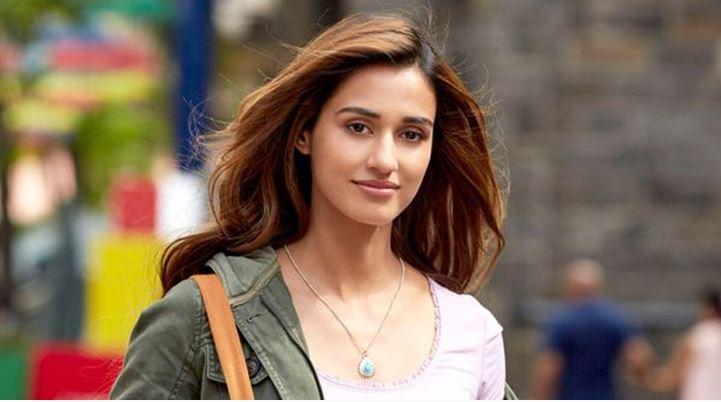 Disha Patani in open hair hanging hand bag and wearing jacket with silver necklace